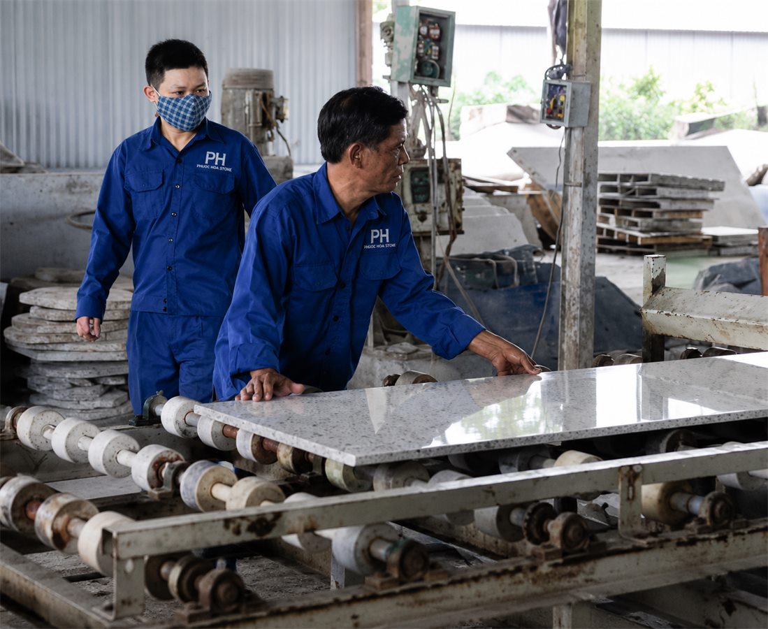 Workers finishing a stone surface